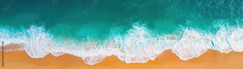 Stunning aerial view of ocean waves gently crashing onto a sandy beach under a clear blue sky, perfect for travel and nature-related projects. Stunning aerial view of ocean waves gently crashing onto a sandy beach under a clear blue sky, perfect for travel and nature-related projects.