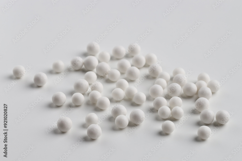 Homeopathic remedy. Many round pills on white background Homeopathic remedy. Many round pills on white background