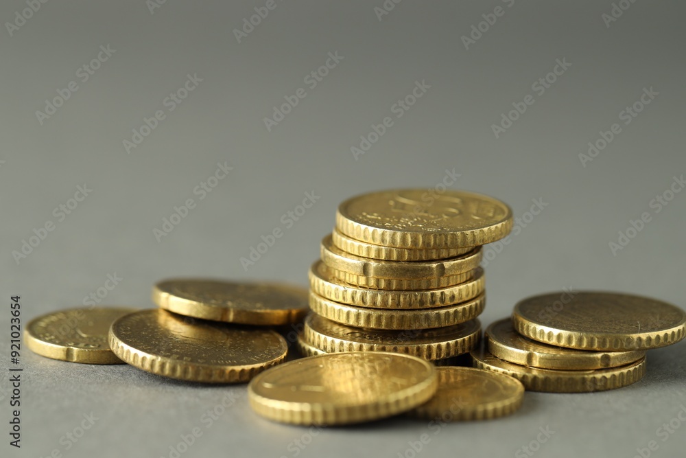 Many euro coins on grey background, closeup Many euro coins on grey background, closeup