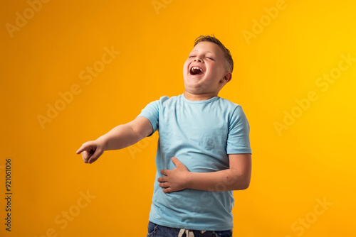 Kid boy laughing at somebody and pointing finger. Bulling concept photo