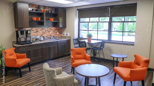 A business office with a cozy break area, complete with coffee machines and comfortable seating.