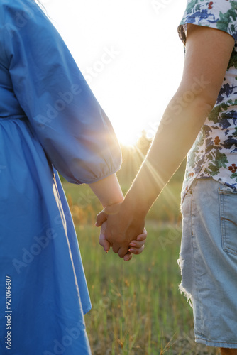 A couple in love holding hands at sunset