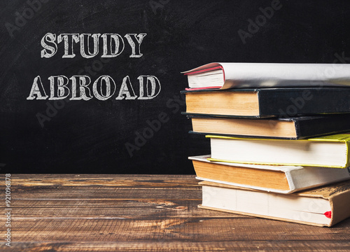 A stack of books with the word study abroad written on top