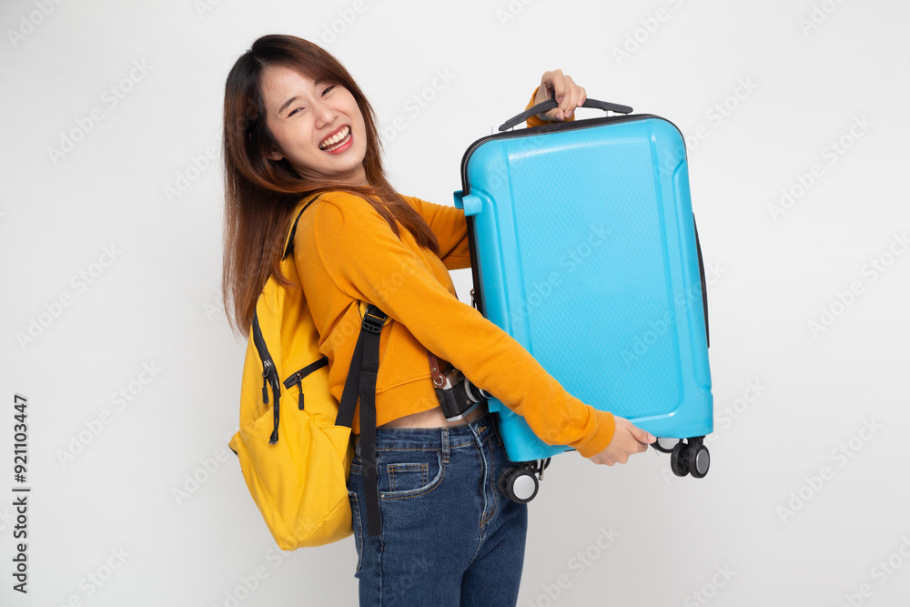 Happy Asia woman traveler standing and holding suitcase isolated on white background, Tourist girl having cheerful holiday trip concept Happy Asia woman traveler standing and holding suitcase isolated on white background, Tourist girl having cheerful holiday trip concept