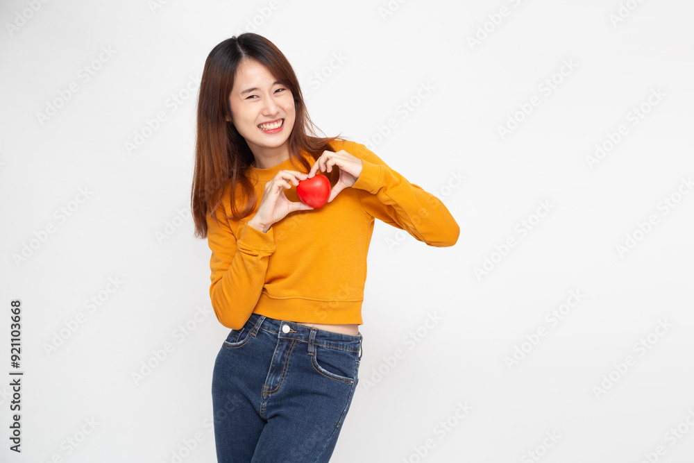 Young Asian woman holding red love heart sign isolated on white background Young Asian woman holding red love heart sign isolated on white background