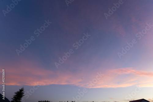 The sky, a canvas painted with strokes of ethereal pink, stretched across the horizon, casting a warm, rosy glow upon the tranquil landscape. As the sun dipped below the distant horizon.