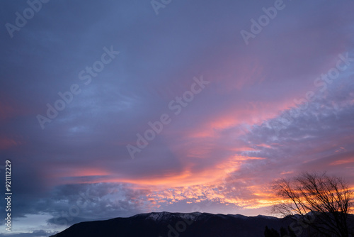 The sky, a canvas painted with strokes of ethereal pink, stretched across the horizon, casting a warm, rosy glow upon the tranquil landscape. As the sun dipped below the distant horizon. photo