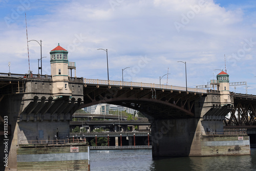 bridge over the river with little towers and blue water photo