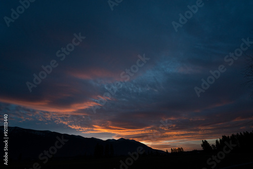 The sky, a canvas painted with strokes of ethereal pink, stretched across the horizon, casting a warm, rosy glow upon the tranquil landscape. As the sun dipped below the distant horizon.