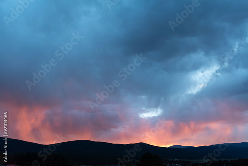 The sky, a canvas painted with strokes of pink, stretched across the horizon, casting a rosy glow upon the tranquil landscape. Dramatic stormy sky remains.