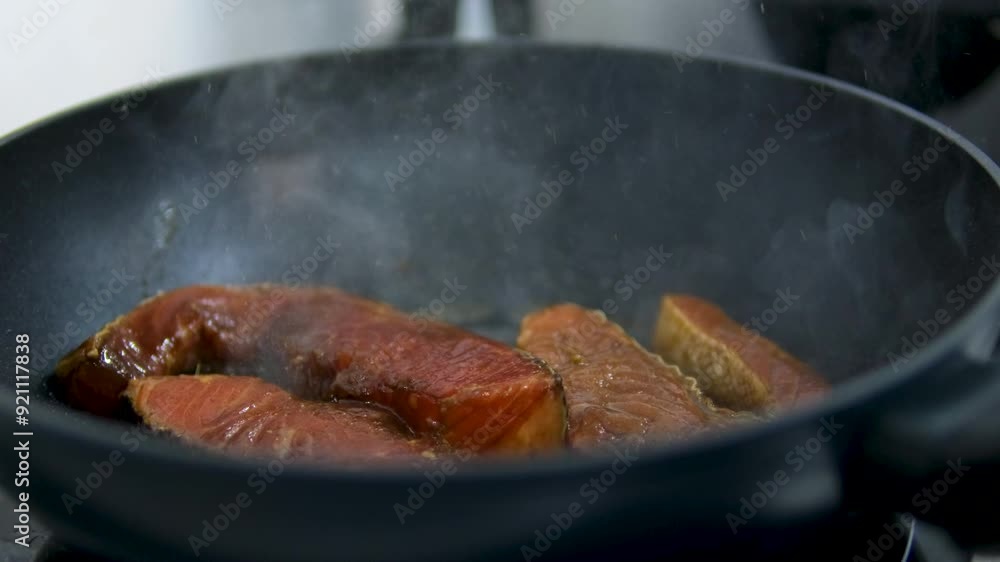 The process of preparing red fish meat in sauce. Steak with red fish.Fish dish.Restaurant concept. chef cooking salmon steaks in the kitchen The process of preparing red fish meat in sauce. Steak with red fish.Fish dish.Restaurant concept. chef cooking salmon steaks in the kitchen
