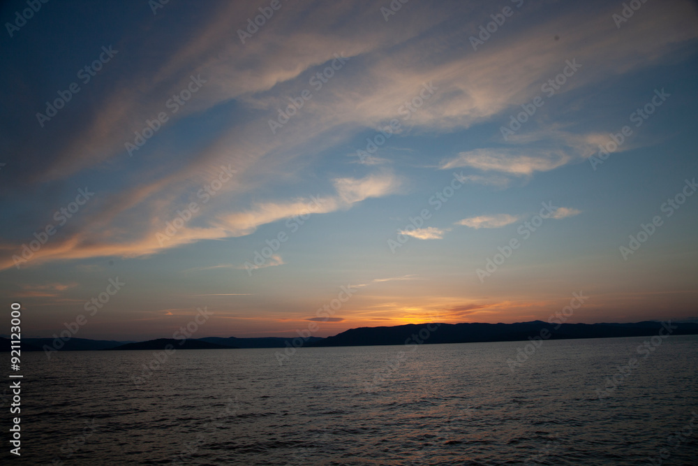 Sunlight sky over a lake during sunset hours Sunlight sky over a lake during sunset hours