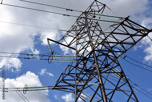 High voltage power line on blue sky background in Sunny day. wires, problems with electricity, power transmission. power line construction of cable supports and insulators. blackout, crisis photo