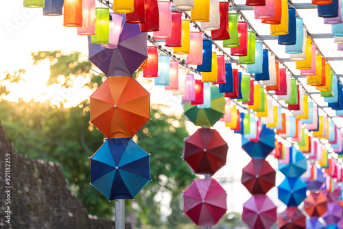 Beautiful lanterns hanging from the corners of the pillars and colorful umbrellas create a warm atmosphere. The lights combined with the spectacular bokeh effect make this a truly enchanting evening. photo