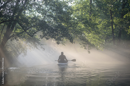 man on a SUP board on a river in fog