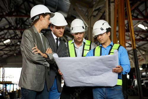 engineers and businesspeople talking about work or project on a construction site