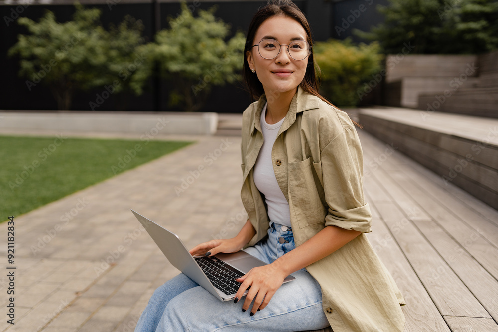 young pretty woman sitting in student campus co-working outside young pretty woman sitting in student campus co-working outside