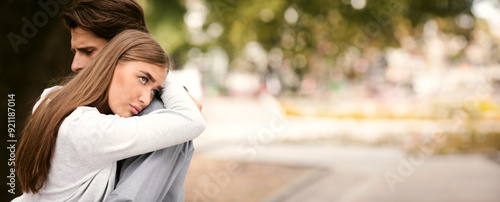 Stuck In Relationship. Unhappy Girl Hugging Unloved Boyfriend Standing Outdoors In Park. Free Space For Text