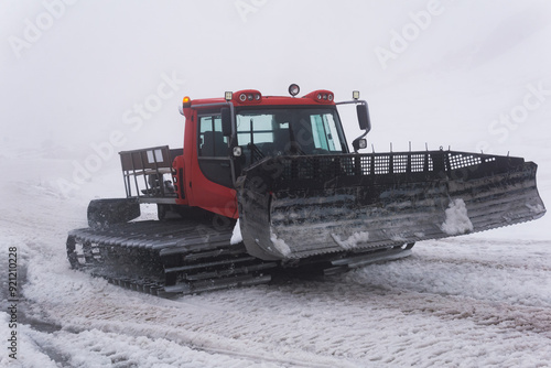 Photography snowcat on a melting ski slope in thick cloudy fog