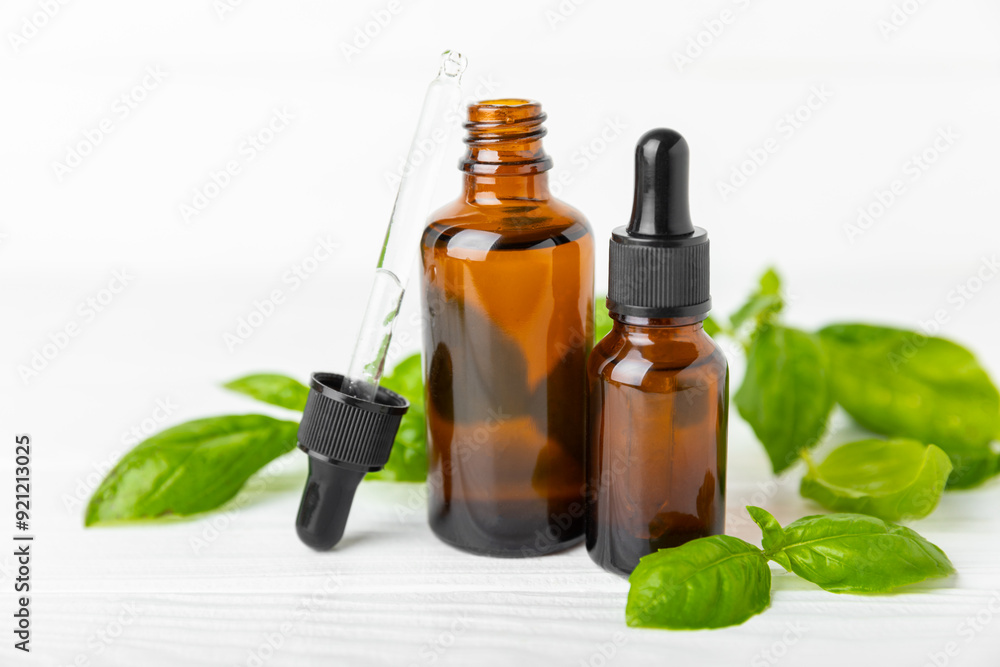 Basil essential oil on a textured wooden background. Basil essential oil and fresh leaves. Aromatherapy. Aroma oil. Medical herbs. Alternative medicine. Place for text. Copy space. Basil essential oil on a textured wooden background. Basil essential oil and fresh leaves. Aromatherapy. Aroma oil. Medical herbs. Alternative medicine. Place for text. Copy space.