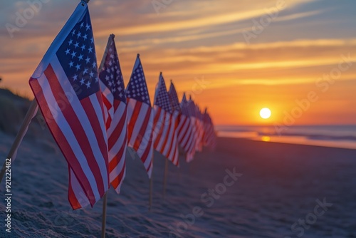 Fototapeta Naklejka Na Ścianę i Meble -  American Flags Line Up on Sandy Beach at Sunset