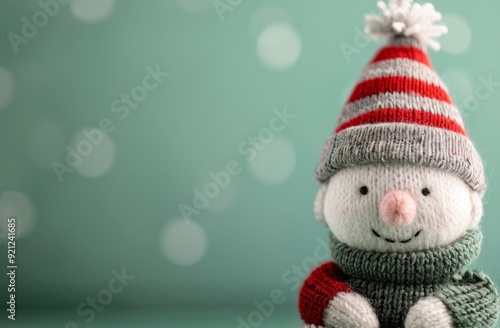 Festive Knit Snowman Ornament on Soft Green Background With Bokeh Lights