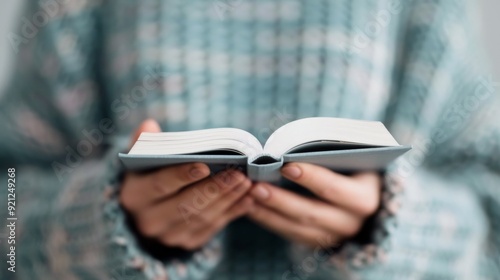 Hands on Open Book With Intricate Patterns in a Softly Lit Environment