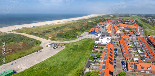 The coastal town of Ter Heijde aan Zee features a blend of green fields, sandy beaches, and vibrant rooftops 