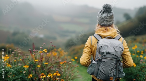 Hiker Exploring Vibrant Meadows Near a Serene Lake in Overcast Weather