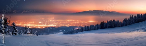 Snow-Covered Mountains at Dusk With Light Glowing in the Valley