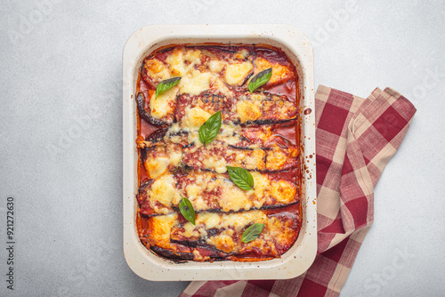 Obraz na plátne Eggplant parmigiana di melanzane freshly baked and decorated with basil leaves, resting in a baking pan