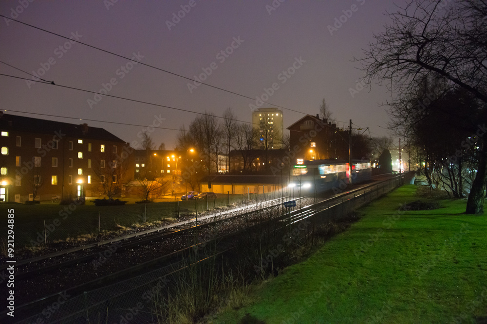 Old electric tram passing a dark stretch of a tram line. Old electric tram passing a dark stretch of a tram line.