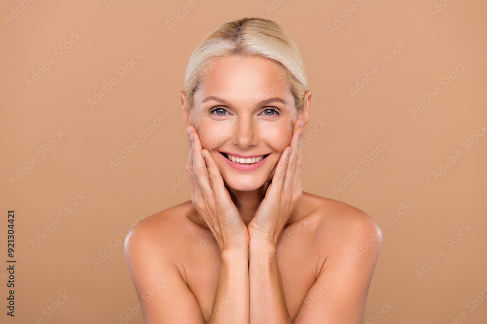 Photo of charming cute nude lady wear nothing arms hands cheekbones sheeks smiling isolated beige color background Photo of charming cute nude lady wear nothing arms hands cheekbones sheeks smiling isolated beige color background