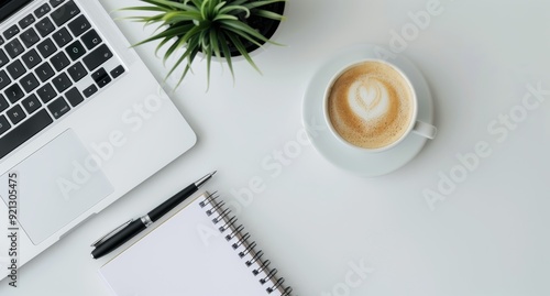 Modern Workspace With Laptop, Mug, and Potted Plant on White Desk