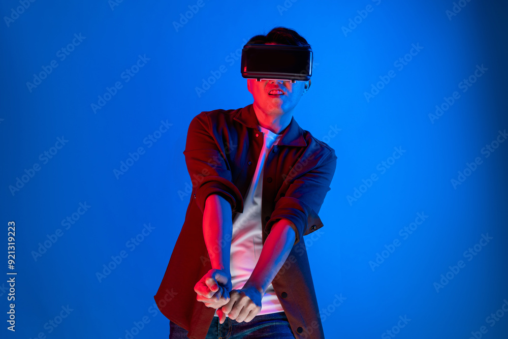 Smart gaming player wearing VR glasses playing golf distance course hologram isolated neon light blue screen connecting digital futuristic technology virtual reality in metaverse world. Contrivance. Smart gaming player wearing VR glasses playing golf distance course hologram isolated neon light blue screen connecting digital futuristic technology virtual reality in metaverse world. Contrivance.
