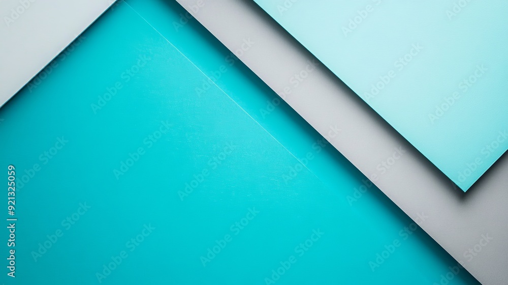 Abstract composition with teal and gray geometric shapes on a flat surface Abstract composition with teal and gray geometric shapes on a flat surface
