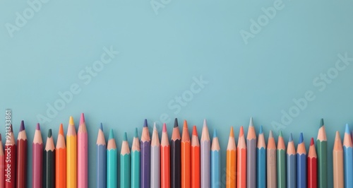Colorful Pencils Arranged Neatly Against a Blue Background