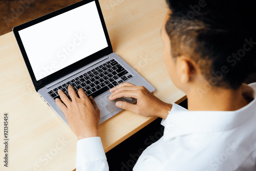 Business person or office worker using laptop computer while sitting at desk. uds