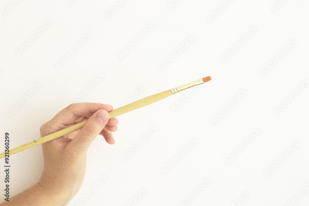 hand with paintbrush hand with paintbrush