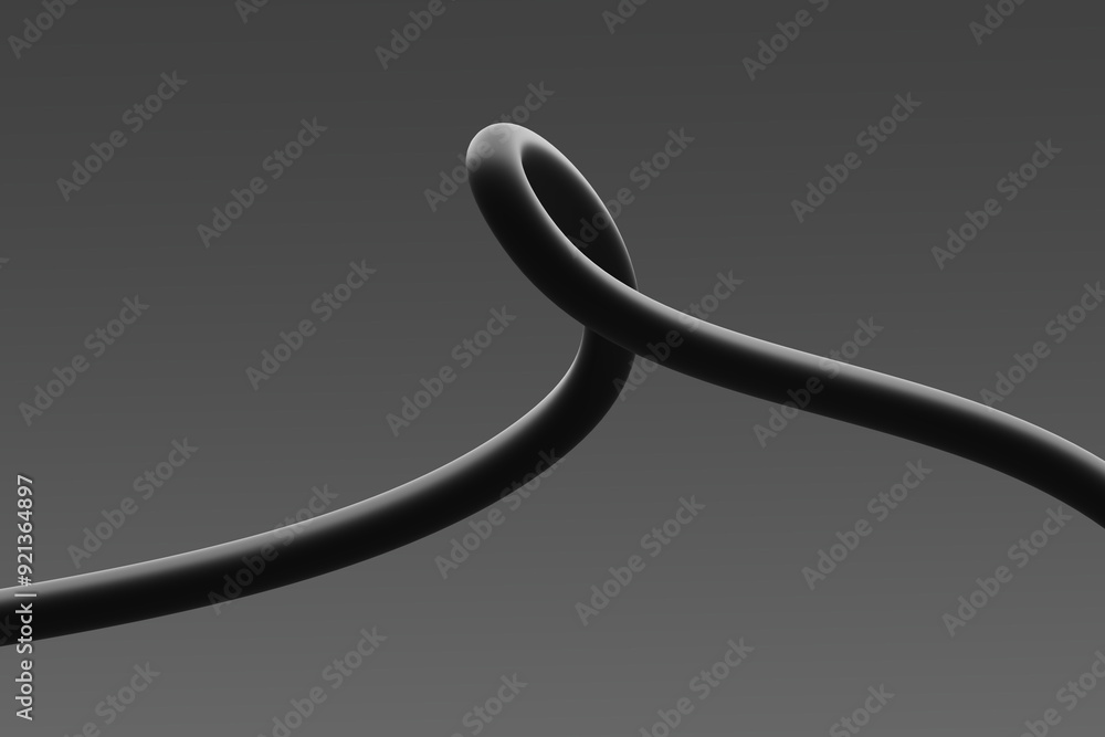 A close-up view of a looped black cable against a grey background