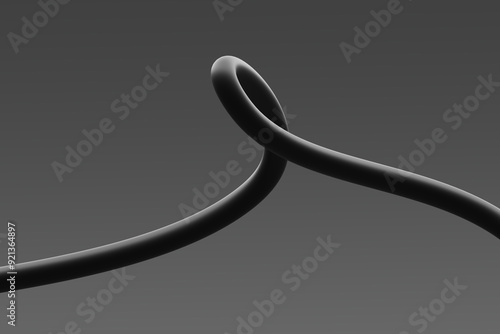 Obraz na płótnie A close-up view of a looped black cable against a grey background w salonie
