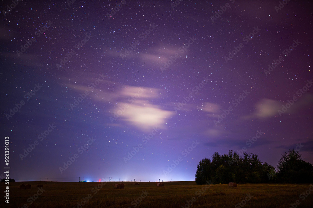night starry sky outside the city with purple reflections of the northern lights night starry sky outside the city with purple reflections of the northern lights