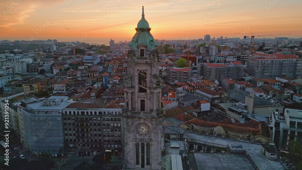 Obraz premium Drone historic town evening on sunset. Old clock tower in city center evening