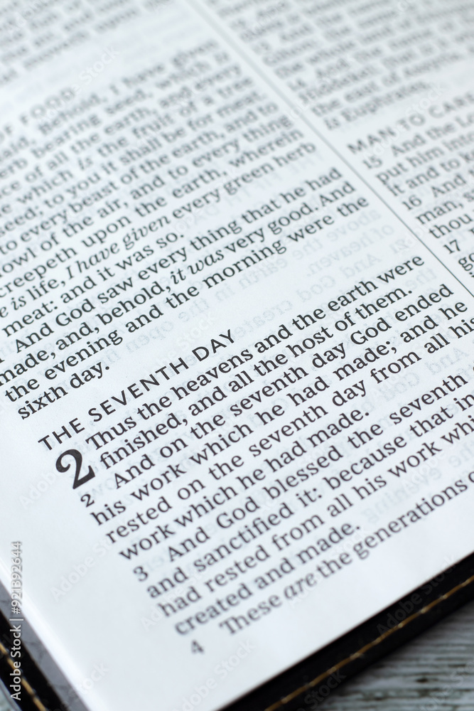 Seventh day Sabbath rest verses in open holy bible book. Close-up. Selective focus. Christian worship, blessing, obedience to God Jesus Christ, biblical concept. Seventh day Sabbath rest verses in open holy bible book. Close-up. Selective focus. Christian worship, blessing, obedience to God Jesus Christ, biblical concept.