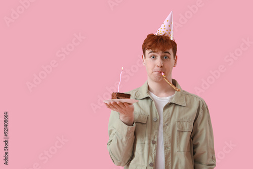Young man with party blower...