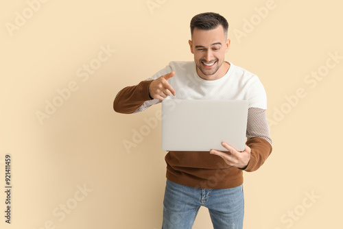 Happy young man pointing at...