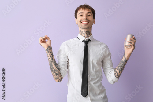 Happy young man with can of...