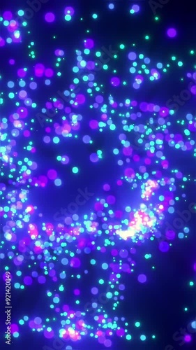 Colorful light particles swirl in a mesmerizing pattern at night