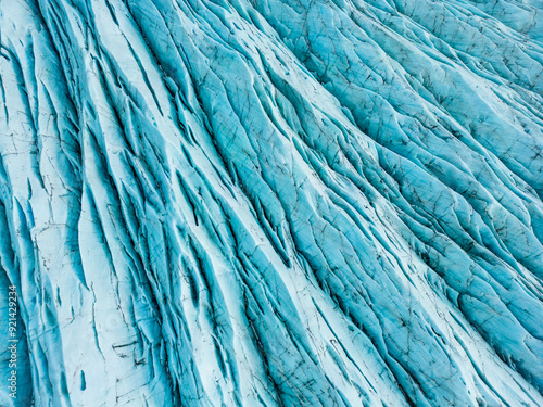 Aerial view of massive ice blocks on vatnajokull glacier in iceland, spectacular frozen landscape with caves and cracked chunks. Beautiful frosty icelandic nature with crevasse. photo