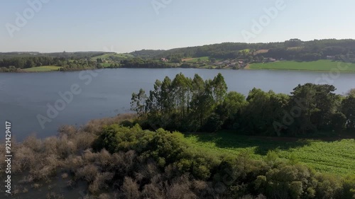 Wallpaper Mural Drone shot of the idyllic scenery in Villagudin, Spain, featuring a lake surrounded by mountains Torontodigital.ca